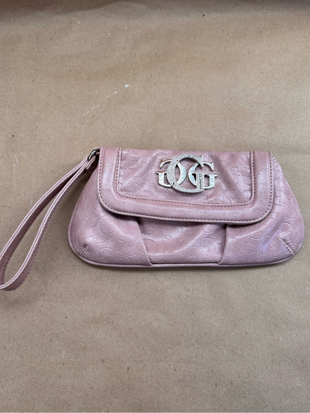 Guess Dusty Rose Wristlet with Rhinestone Logo. 9” by 5” by 0.5”